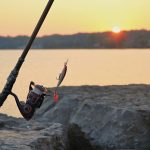 Fishing rod and lure at sunrise on a rocky pier in Webster Lake, NY. — Casinospinsyfr : Unveiling the Ultimate Online Gaming