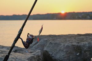 Fishing rod and lure at sunrise on a rocky pier in Webster Lake, NY. — Casinospinsyfr : Unveiling the Ultimate Online Gaming