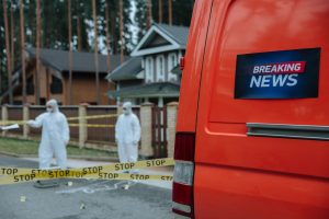 Forensic investigators in protective suits work at a marked-off crime scene near concrete houses. — Methmeth Casino: Mobile S