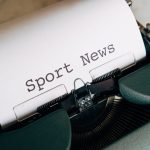 Close-up of a vintage typewriter with 'Sport News' typed on paper, evoking retro charm. — SupaBet Casino: Tu Carrera hacia Gr